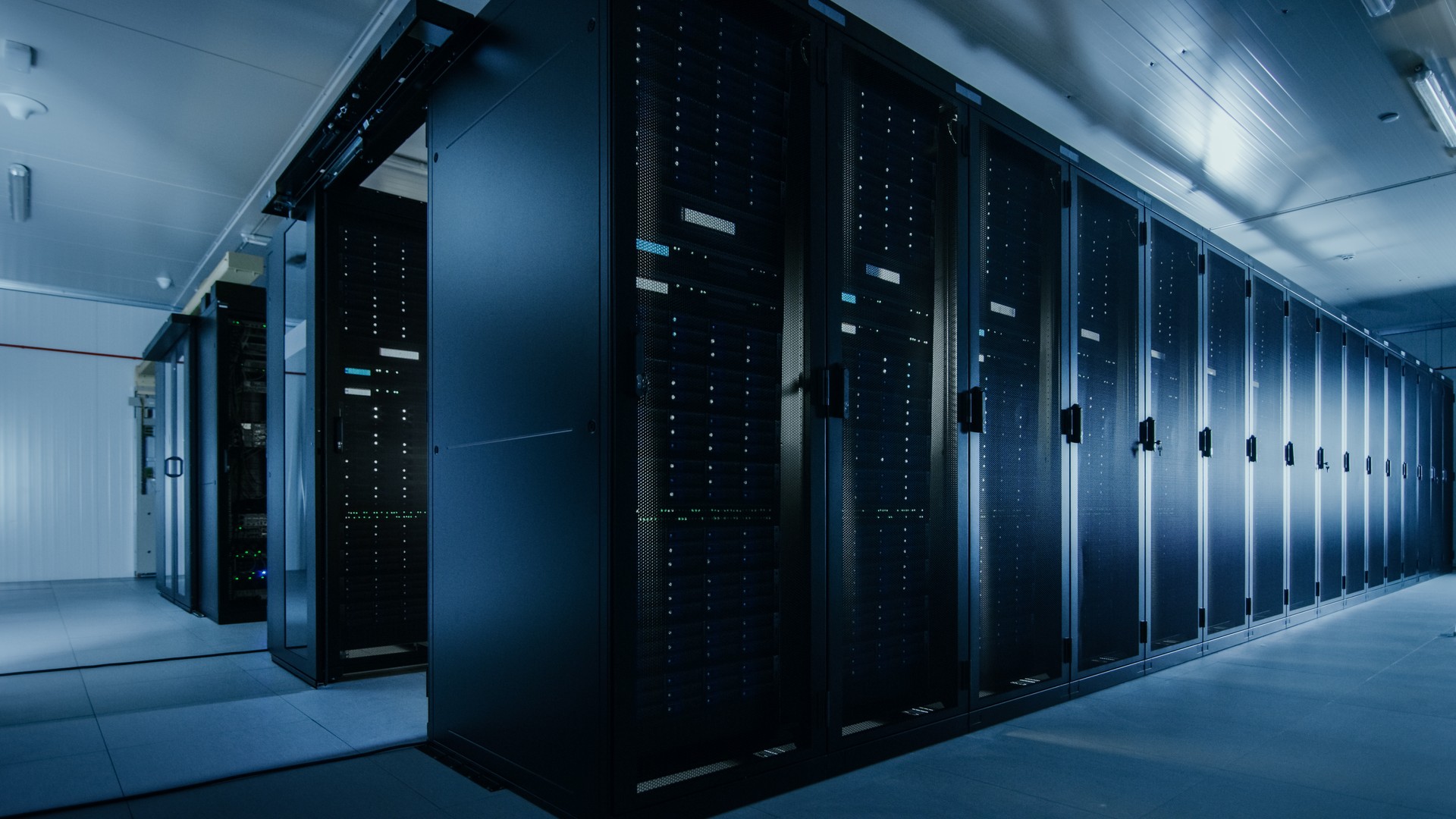 Shot of a Working Data Center With Rows of Rack Servers. Led Lights Blinking and Computers are Working.