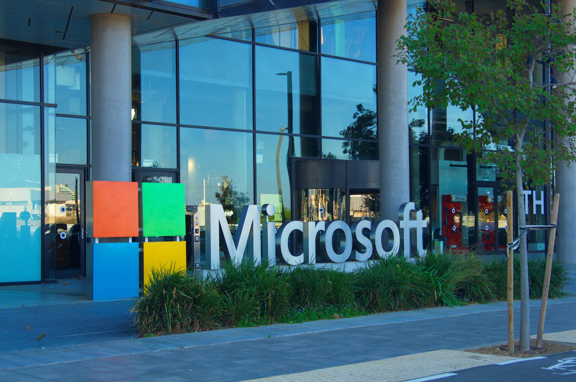 Big letters on the grass - Microsoft. Logo of a computer corporation at the entrance to the building