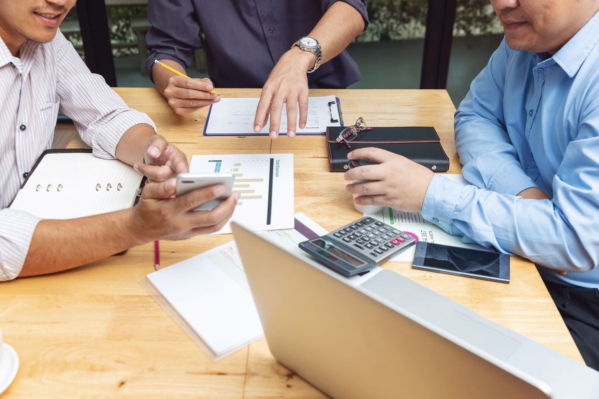 Business and finance concept of office working,Top view of Teamwork of Businessmen discussing business investment plan in office